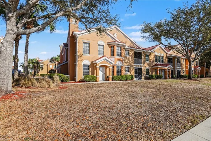 View of front of home with a chimney and stucco siding