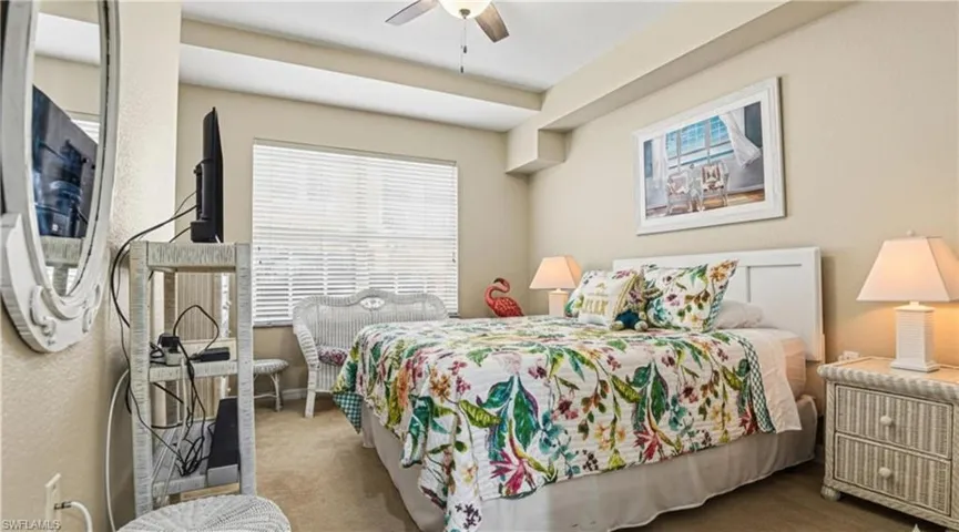 Carpeted bedroom featuring a ceiling fan and baseboards