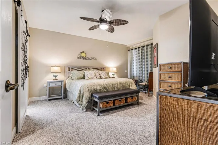 Bedroom featuring light colored carpet and ceiling fan