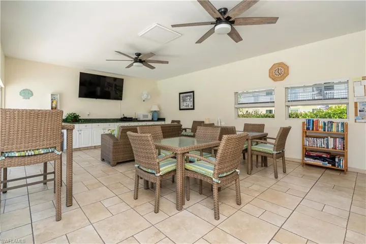 Tiled dining space featuring ceiling fan