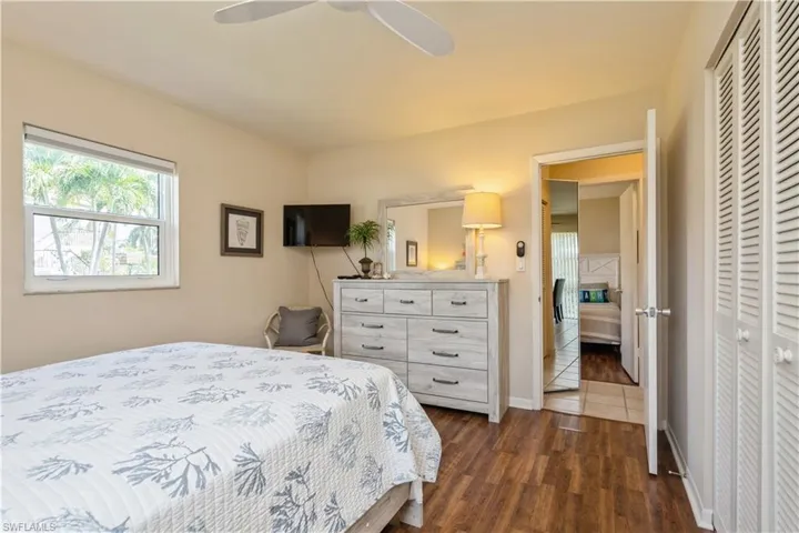 Bedroom featuring a closet, ceiling fan, and dark hardwood / wood-style floors
