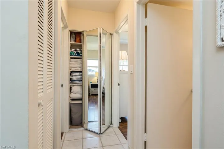 Corridor with light tile patterned floors