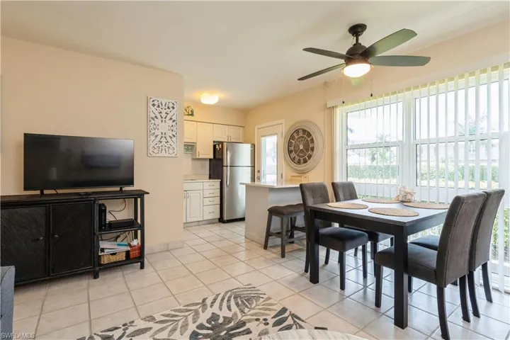 Tiled dining area featuring ceiling fan