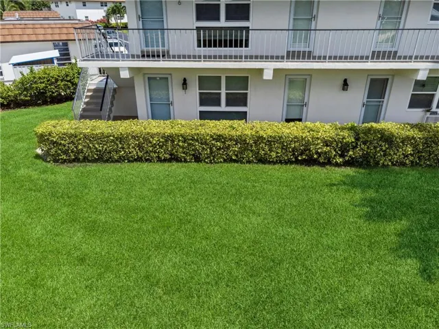 View of property's community with a yard