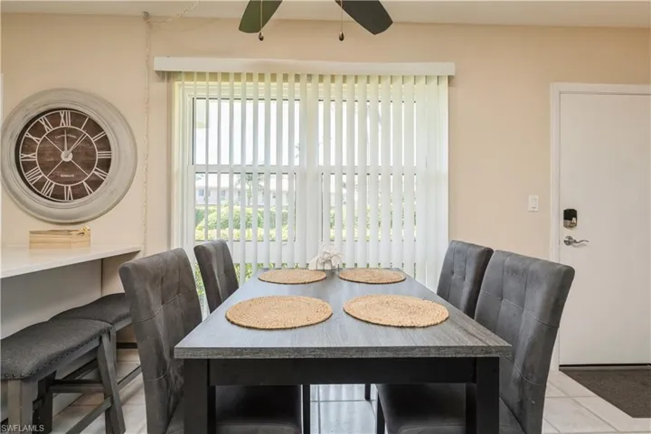 Tiled dining room with ceiling fan