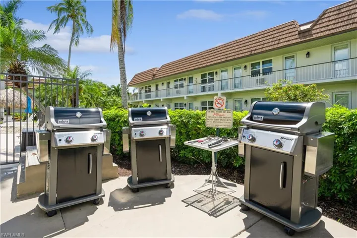 View of patio with area for grilling and a balcony