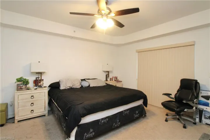 Carpeted bedroom with ceiling fan