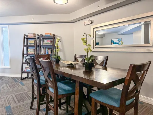 Dining area with dark colored carpet