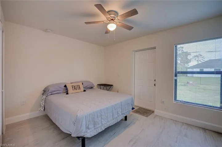 Bedroom with baseboards and a ceiling fan