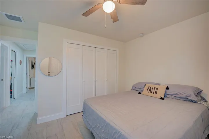 Bedroom with a closet and a ceiling fan