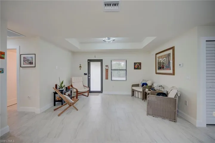Foyer entrance with a raised ceiling