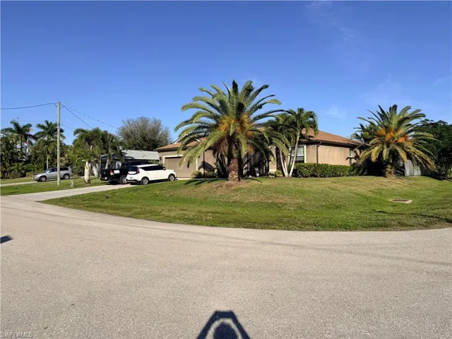 View of front of house with a front lawn and driveway