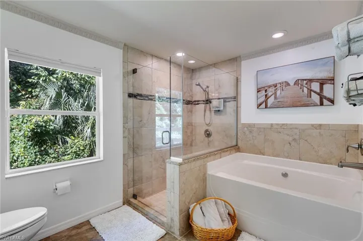 Full bath featuring a bath, a shower stall, recessed lighting, and tile patterned flooring
