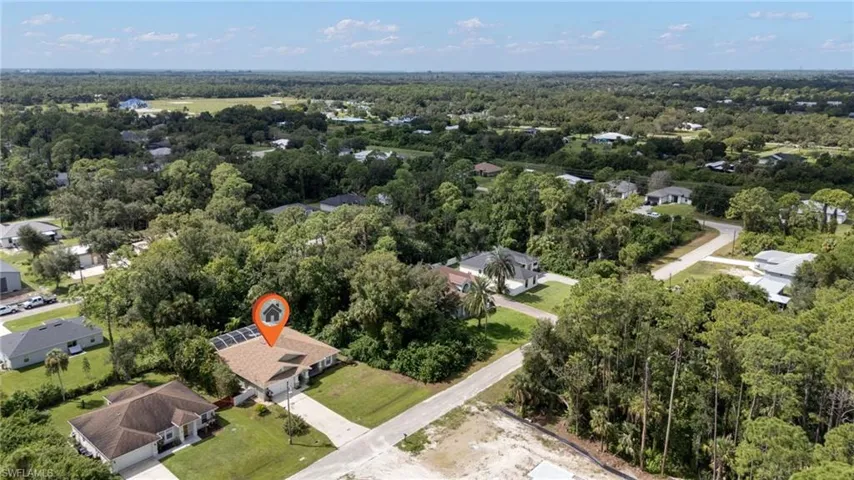 Aerial perspective of suburban area with a forest