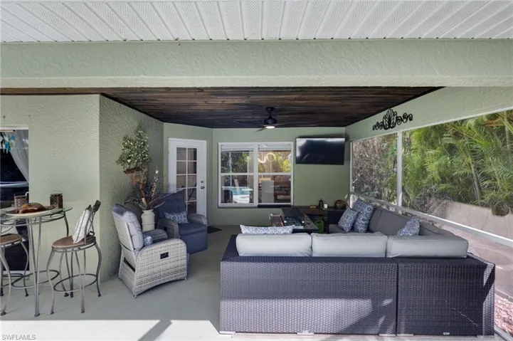 View of patio with a ceiling fan and an outdoor hangout area