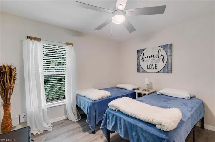 Bedroom with light wood finished floors and a ceiling fan
