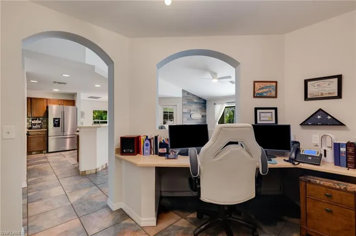 Home office featuring healthy amount of natural light, arched walkways, ceiling fan, and recessed lighting