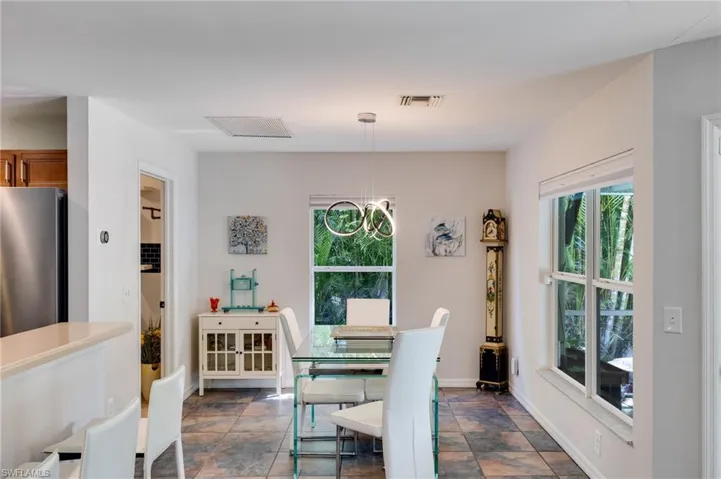 Dining room featuring stone finish flooring and baseboards