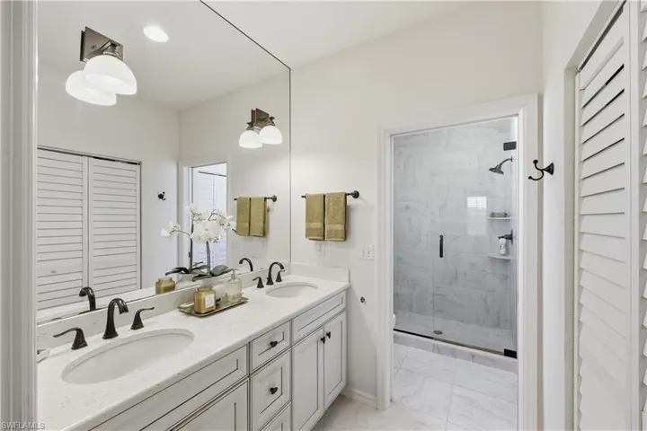 Updated bathroom with a tiled shower and frameless glass enclosure