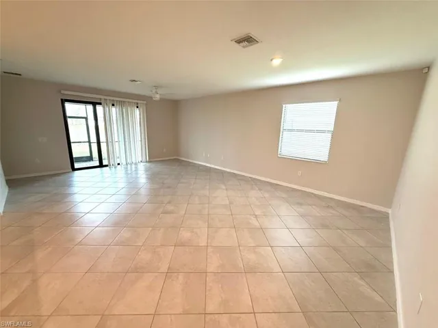Spare room with healthy amount of natural light and light tile patterned floors