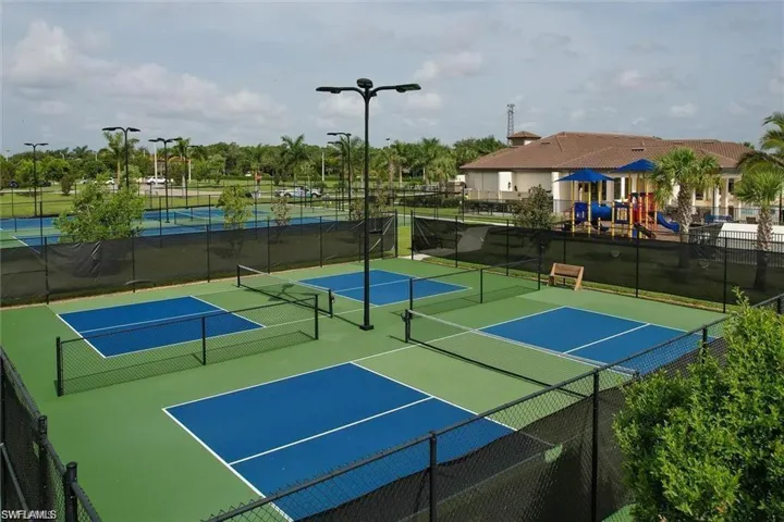 View of tennis court with community basketball court