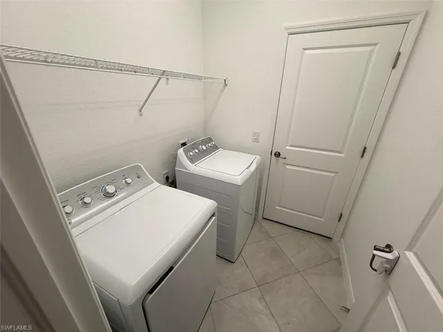 Washroom featuring washing machine and clothes dryer