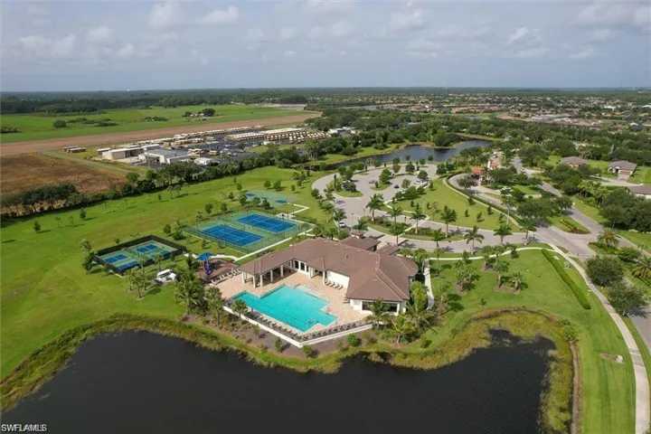 Drone / aerial view of a pool area and a nearby body of water