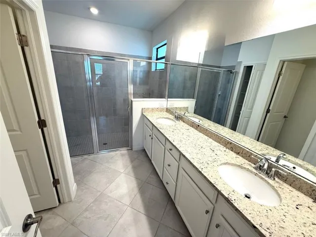 Bathroom with a shower stall and double vanity
