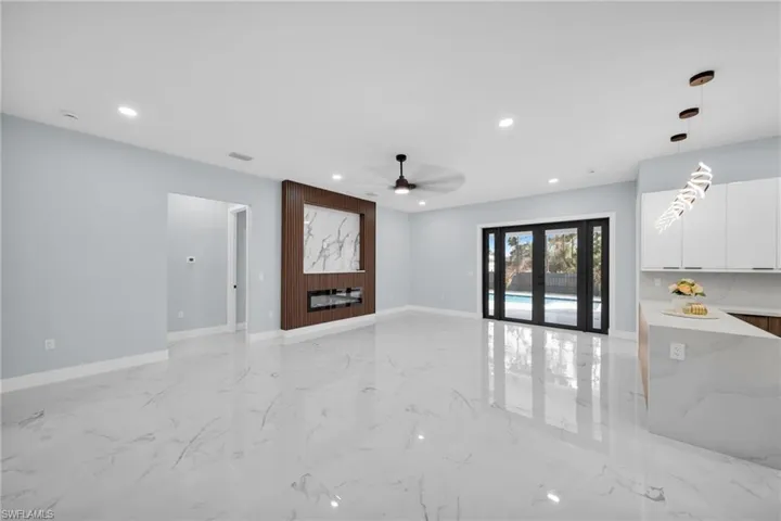 Unfurnished living room featuring ceiling fan, french doors, and recessed lighting