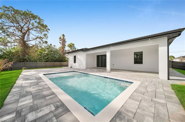 Back of property featuring a fenced backyard, a patio area, and stucco siding