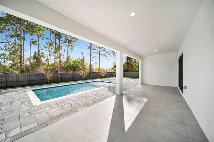 View of pool featuring patio surround and a fenced backyard