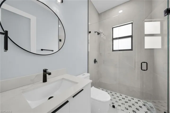 Full bath with vanity and a shower stall