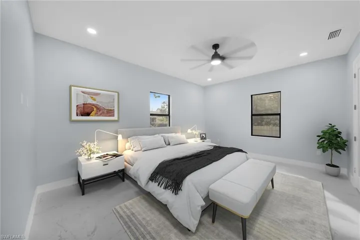 Bedroom with ceiling fan and recessed lighting