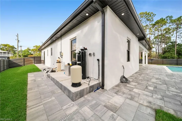 Rear view of house featuring a patio area, a fenced backyard, and stucco siding