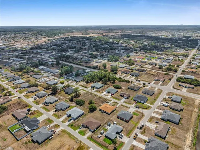 Aerial view of property's location featuring nearby suburban area