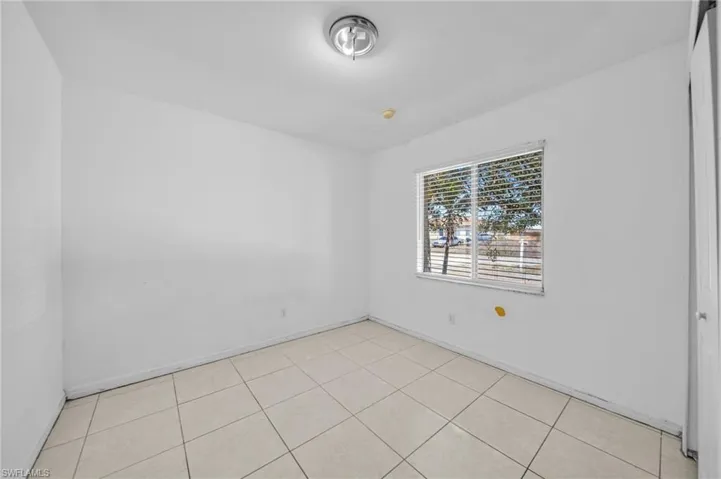 Spare room with light tile patterned flooring