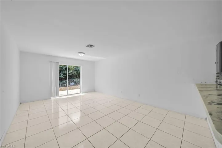Unfurnished room with light tile patterned flooring