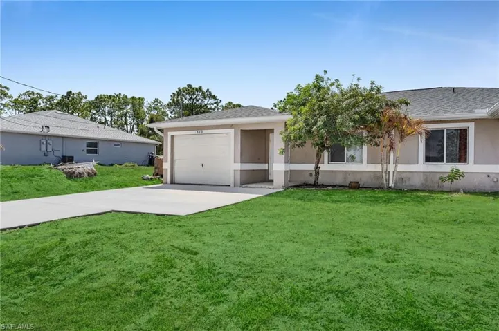 Single story home with driveway, a front lawn, stucco siding, a shingled roof, and a garage