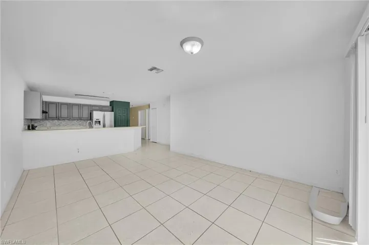Unfurnished living room featuring light tile patterned floors