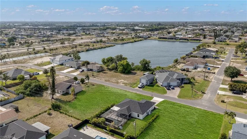 Aerial view of a residential area featuring a prominent lake