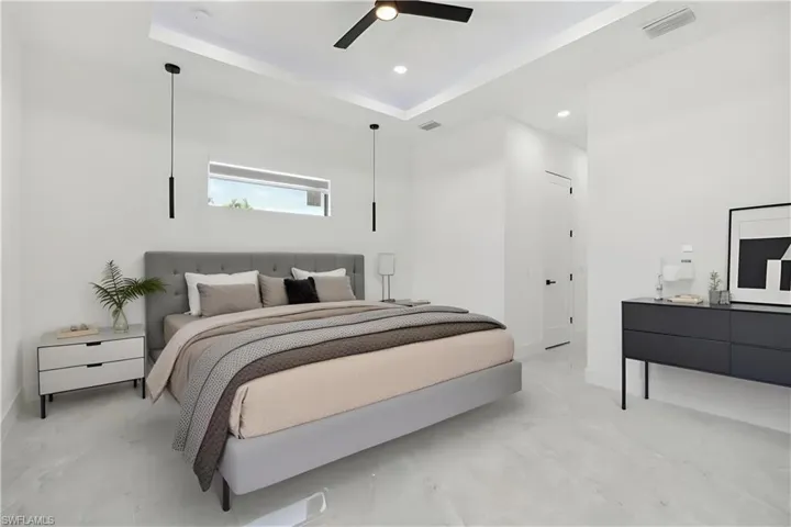 Bedroom featuring a raised ceiling and ceiling fan