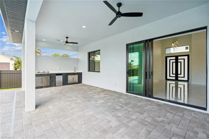 View of patio featuring area for grilling and ceiling fan