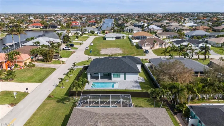 Birds eye view of property with a water view