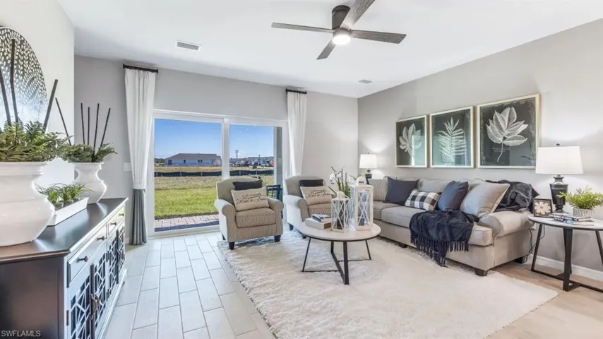 Living room featuring ceiling fan and light hardwood / wood-style flooring