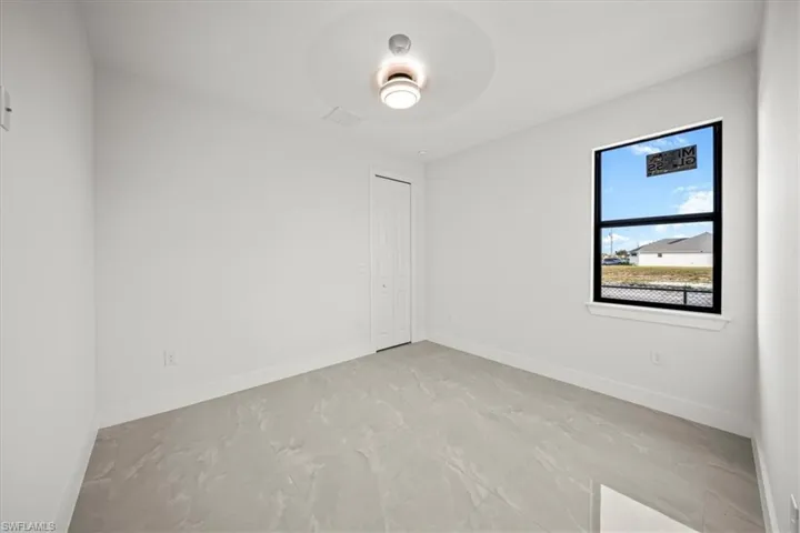 Unfurnished room with baseboards