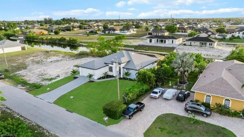 Aerial perspective of suburban area featuring a large body of water