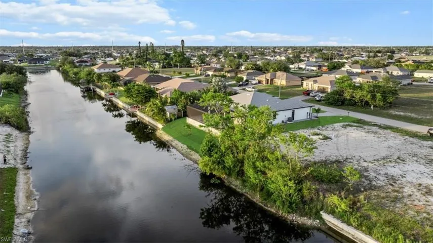 Aerial view of residential area featuring a nearby body of water