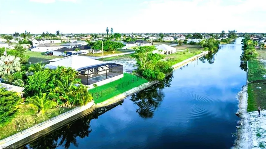 Aerial view of residential area featuring a large body of water