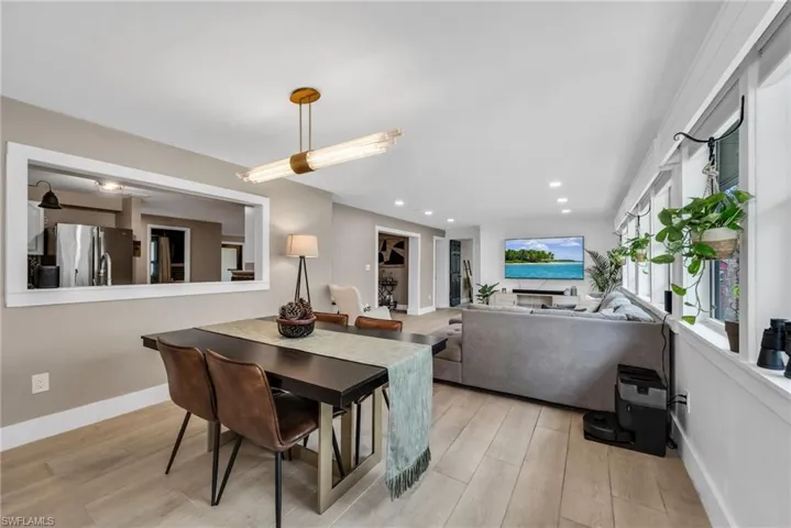 Dining area featuring pendant light, recessed lighting and wood plank porcelain tile flooring