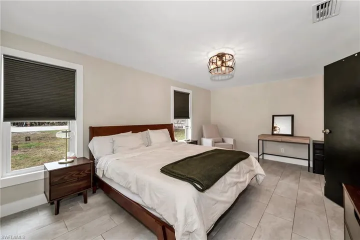 Bedroom featuring limewash paint and tile flooring